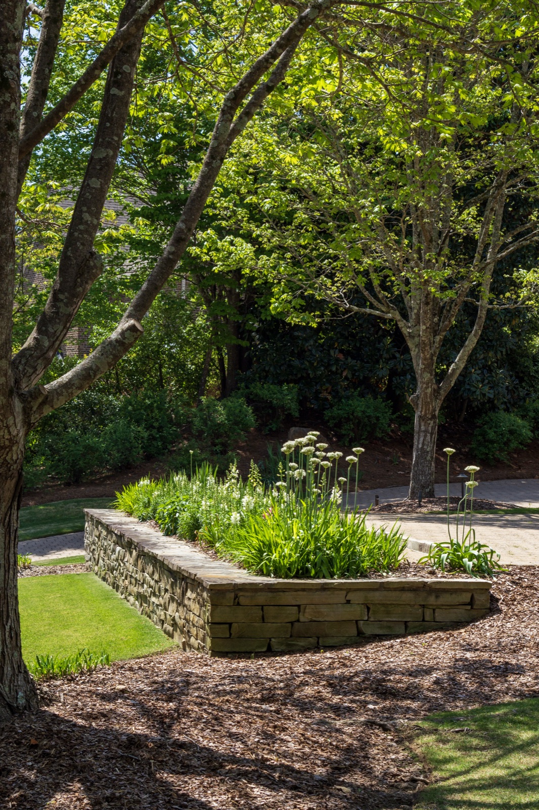 Hardscaping — stone retaining wall with garden